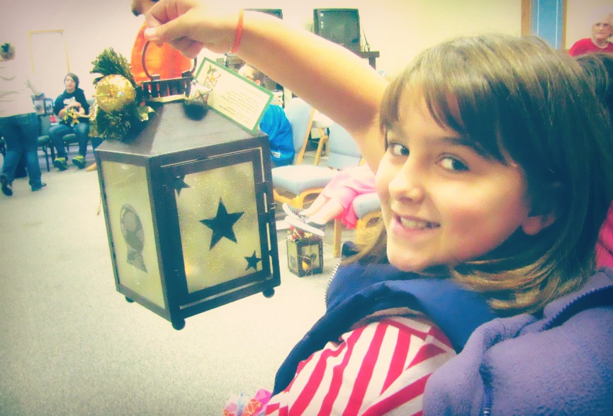 A girl holding a holiday ornament